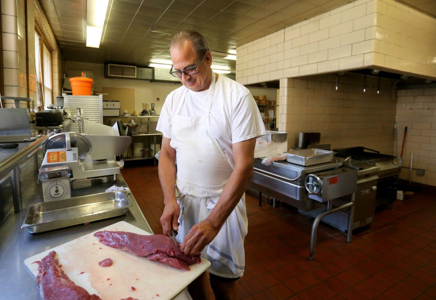 Craig Spielman cuts meat at Creative Catering in Dubuque on Thursday, Sept. 8, 2022.    PHOTO CREDIT: JESSICA REILLY