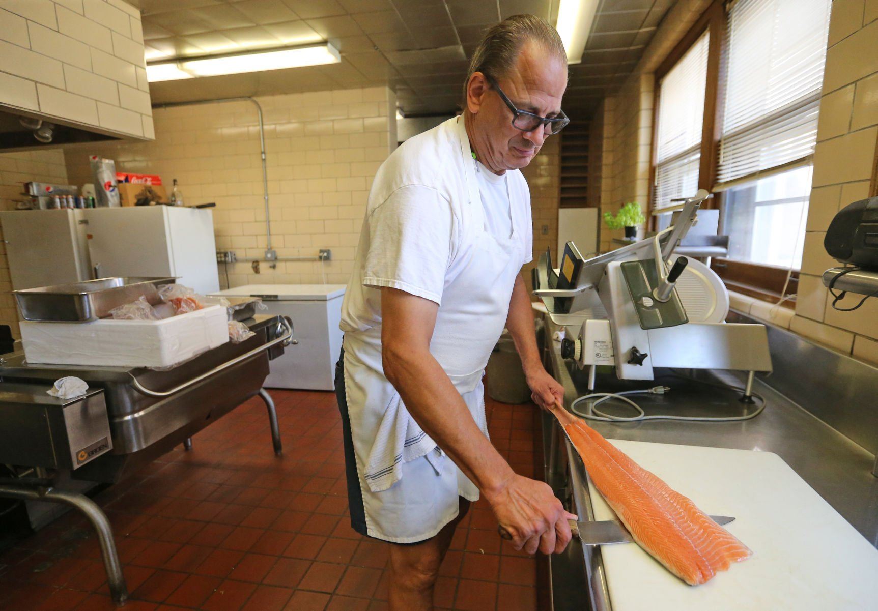Craig Spielman prepares food at Creative Catering in Dubuque on Thursday.    PHOTO CREDIT: JESSICA REILLY