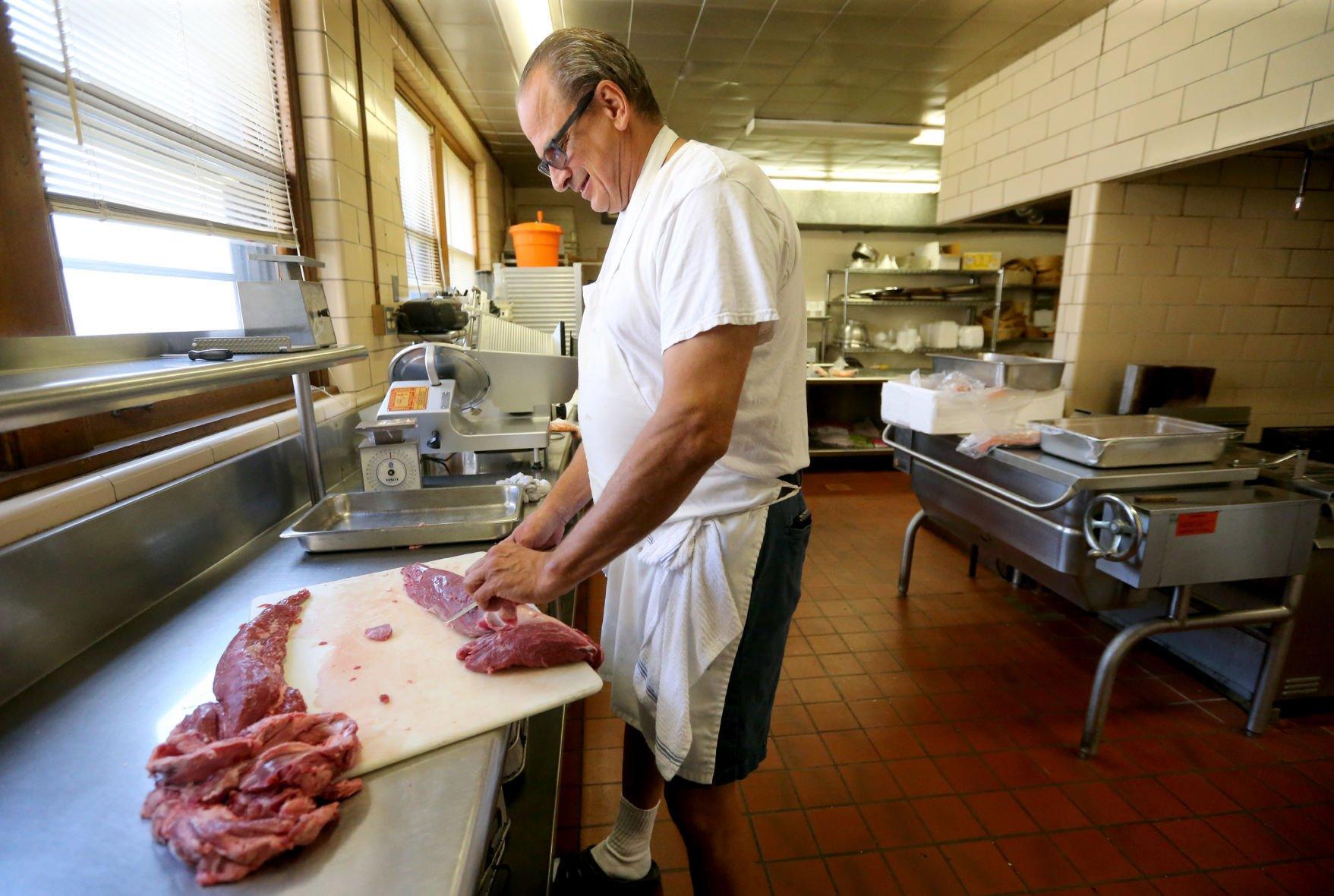 Craig Spielman cuts meat at Creative Catering in Dubuque on Thursday, Sept. 8, 2022.    PHOTO CREDIT: JESSICA REILLY