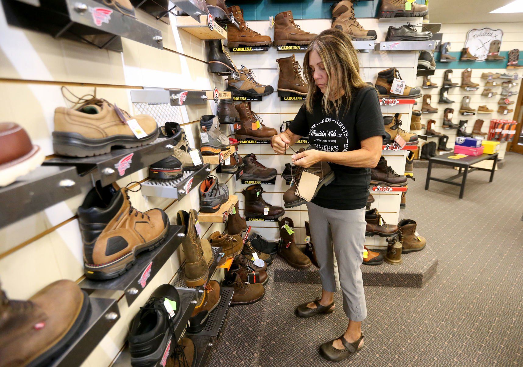 Mary Hawes sorts shoes. There are an estimated 20,000 pairs of shoes at the location.    PHOTO CREDIT: JESSICA REILLY