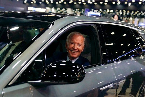 President Joe Biden drives a Cadillac Lyriq through the show room during a tour at the Detroit Auto Show, Wednesday, Sept. 14, 2022, in Detroit. (AP Photo/Evan Vucci)    PHOTO CREDIT: Evan Vucci