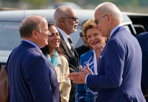 President Joe Biden speaks with Sen. Debbie Stabenow, D-Mich., second from right, Detroit Mayor Mike Duggan and wife Sonia Hassan as he arrives at Detroit Metropolitan Airport, Wednesday, Sept. 14, 2022, in Detroit. (AP Photo/Evan Vucci)    PHOTO CREDIT: Evan Vucci