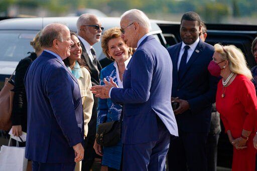 President Joe Biden speaks with Sen. Debbie Stabenow, D-Mich., Detroit Mayor Mike Duggan, left, and wife Sonia Hassan as he arrives at Detroit Metropolitan Airport, Wednesday, Sept. 14, 2022, in Detroit. Rep. Debbie Dingell, D-Mich., right, stands with Environmental Protection Agency Administrator Michael Regan. (AP Photo/Evan Vucci)    PHOTO CREDIT: Evan Vucci