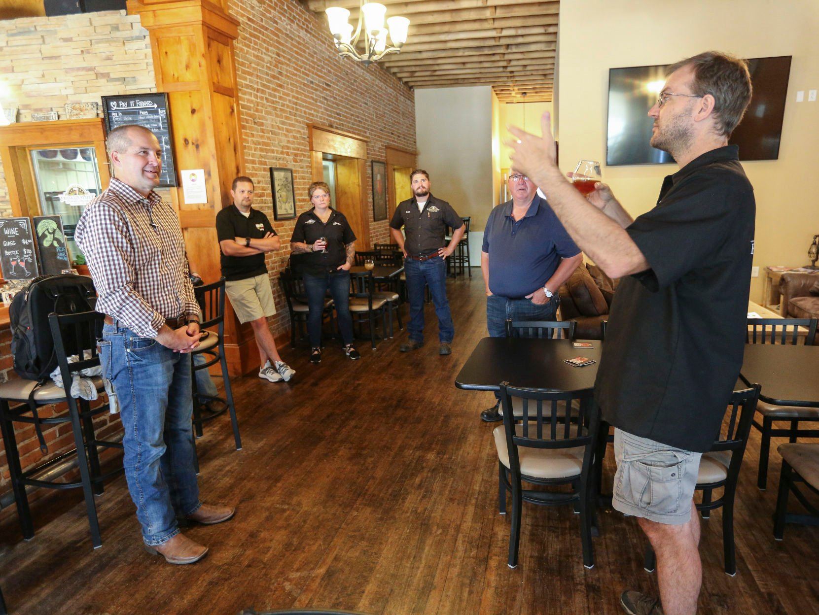 Franklin Street Brewing Company co-owner, Kyle Sands (right), speaks with Iowa Secretary of Agriculture Mike Naig who was in Manchester, Iowa on Thursday, Sept. 15 to tour the company.    PHOTO CREDIT: Dave Kettering