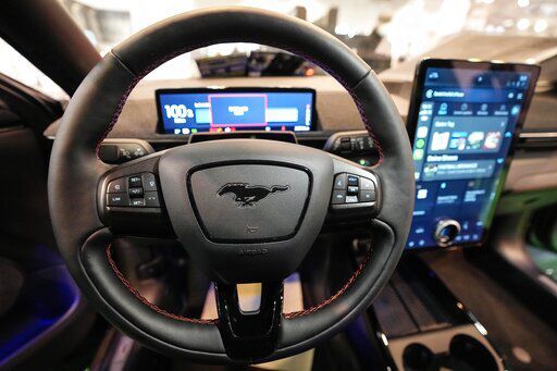 FILE - The cockpit of a Ford Mustang Mach-E electric car is pictured at the Motor Show in Essen, Germany, Thursday, Dec. 2, 2021 (AP Photo/Martin Meissner)    PHOTO CREDIT: Martin Meissner