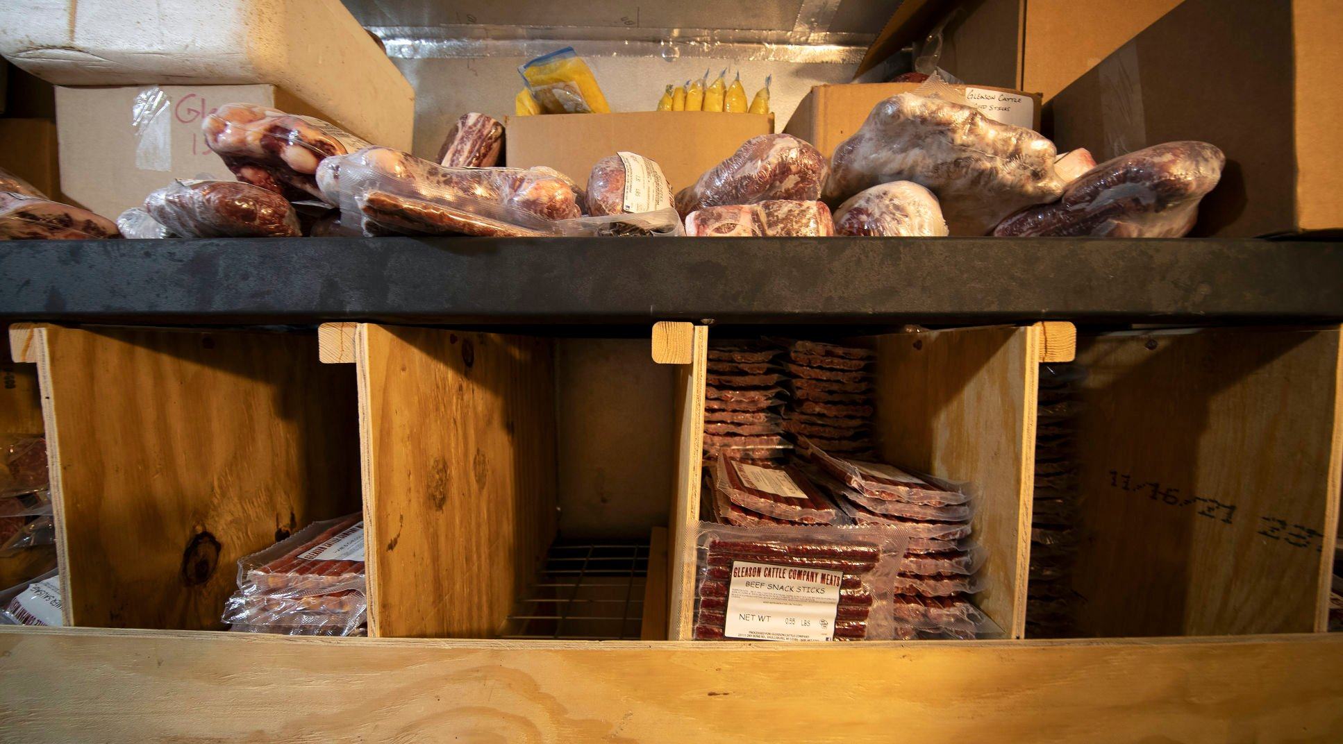 A walk-in cooler stocked with meat from the Gleason