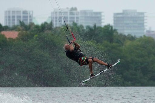 A kite surfer flies in the air as they take advantage of strong winds caused by Hurricane Ian, Tuesday, Sept. 27, 2022, at Matheson Hammock Park in Coral Gables, Fla. (AP Photo/Rebecca Blackwell)    PHOTO CREDIT: Rebecca Blackwell