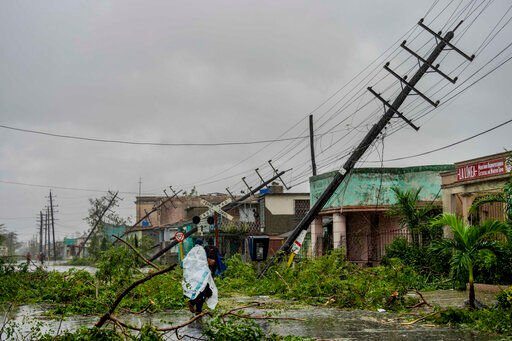Fallen utility poles and fallen branches line a street after Hurricane Ian hit Pinar del Rio, Cuba, Tuesday, Sept. 27, 2022. Ian made landfall at 4:30 a.m. EDT Tuesday in Cuba’s Pinar del Rio province, where officials set up shelters, evacuated people, rushed in emergency personnel and took steps to protect crops in the nation’s main tobacco-growing region. (AP Photo/Ramon Espinosa)    PHOTO CREDIT: Ramon Espinosa