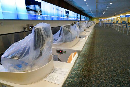 American Airlines check-in counters are closed at Orlando International Airport ahead of Hurricane Ian, Wednesday, Sept. 28, 2022, in Orlando, Fla. (AP Photo/John Raoux)    PHOTO CREDIT: John Raoux