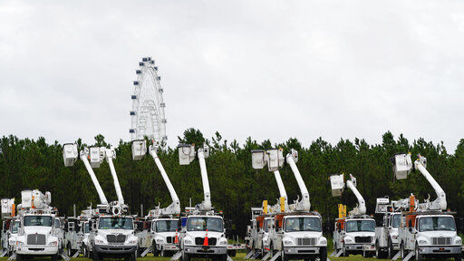 Utility trucks are staged near the Orange County Convention center, ahead of Hurricane Ian, Wednesday, Sept. 28, 2022, in Orlando, Fla. (AP Photo/John Raoux)    PHOTO CREDIT: John Raoux