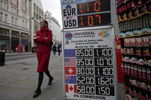 A woman walks past a sign that shows the exchange rate at a bureau de change in London, Tuesday, Sept. 27, 2022. The British pound has stabilized in Asian trading after plunging to a record low, as the Bank of England and the British government try to soothe markets nervous about a volatile U.K. economy. The instability is having real-world impacts, with several British mortgage lenders withdrawing deals amid concern that interest rates may soon rise sharply. (AP Photo/Frank Augstein)    PHOTO CREDIT: Frank Augstein