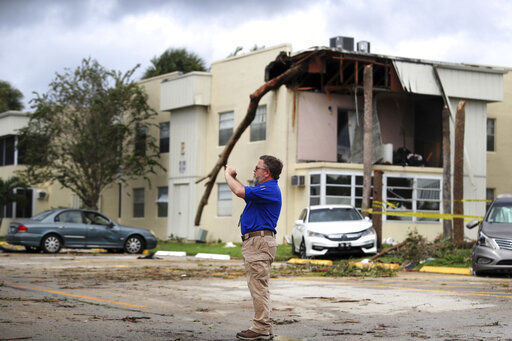 David Dellinger with the National Weather Service, surveys the damage from an apparent overnight tornado spawned from Hurricane Ian at Kings Point 55+ community in Delray Beach, Fla., on Wednesday, Sept. 28, 2022. (Carline Jean /South Florida Sun-Sentinel via AP)    PHOTO CREDIT: Carline Jean