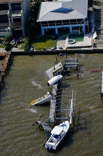 Boats and a damged home are seen in the aftermath of Hurricane Ian, Thursday, Sept. 29, 2022, in Fort Myers Beach, Fla. (AP Photo/Wilfredo Lee)    PHOTO CREDIT: Wilfredo Lee