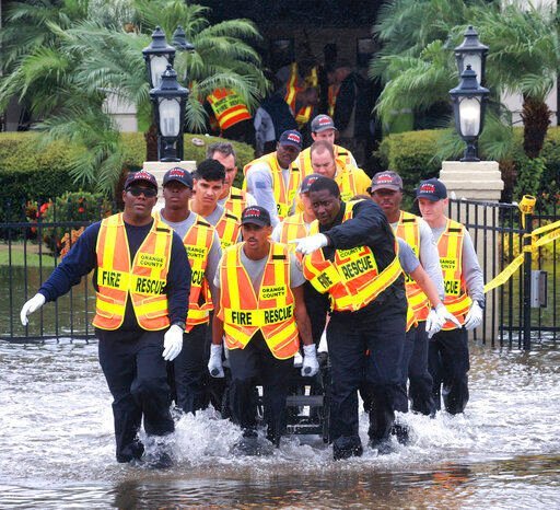 Rescuers evacuate residents from the Avante at Orlando assisted living facility on S.R. 436 in Orlando, Fla., due to flooding from Hurricane Ian, Thursday, Sept. 29, 2022. (Joe Burbank/Orlando Sentinel via AP)    PHOTO CREDIT: Joe Burbank
