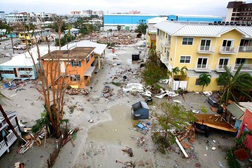Damages homes and businesses are seen in Fort Myers Beach, Fla., on Thursday, Sep 29, 2022, following Hurricane Ian. (Douglas R. Clifford/Tampa Bay Times via AP)    PHOTO CREDIT: Douglas R. Clifford