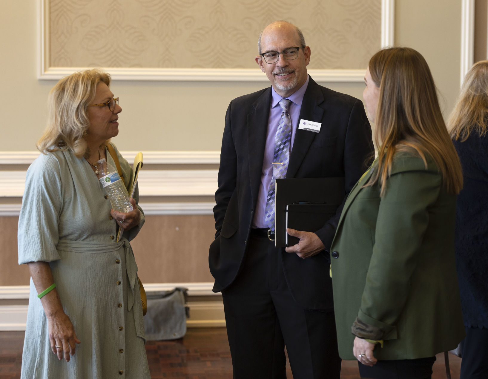 Iowa Sen. Pam Jochum, D-Dubuque, (left) speaks with FEH Design president Kevin Eipperle and Iowa Rep. Lindsay James, D-Dubuque before a panel discussion at the Dubuque Area Chamber of Commerce Legislative Conference at the Hotel Julien Dubuque on Wednesday, Sept. 7.    PHOTO CREDIT: Stephen Gassman