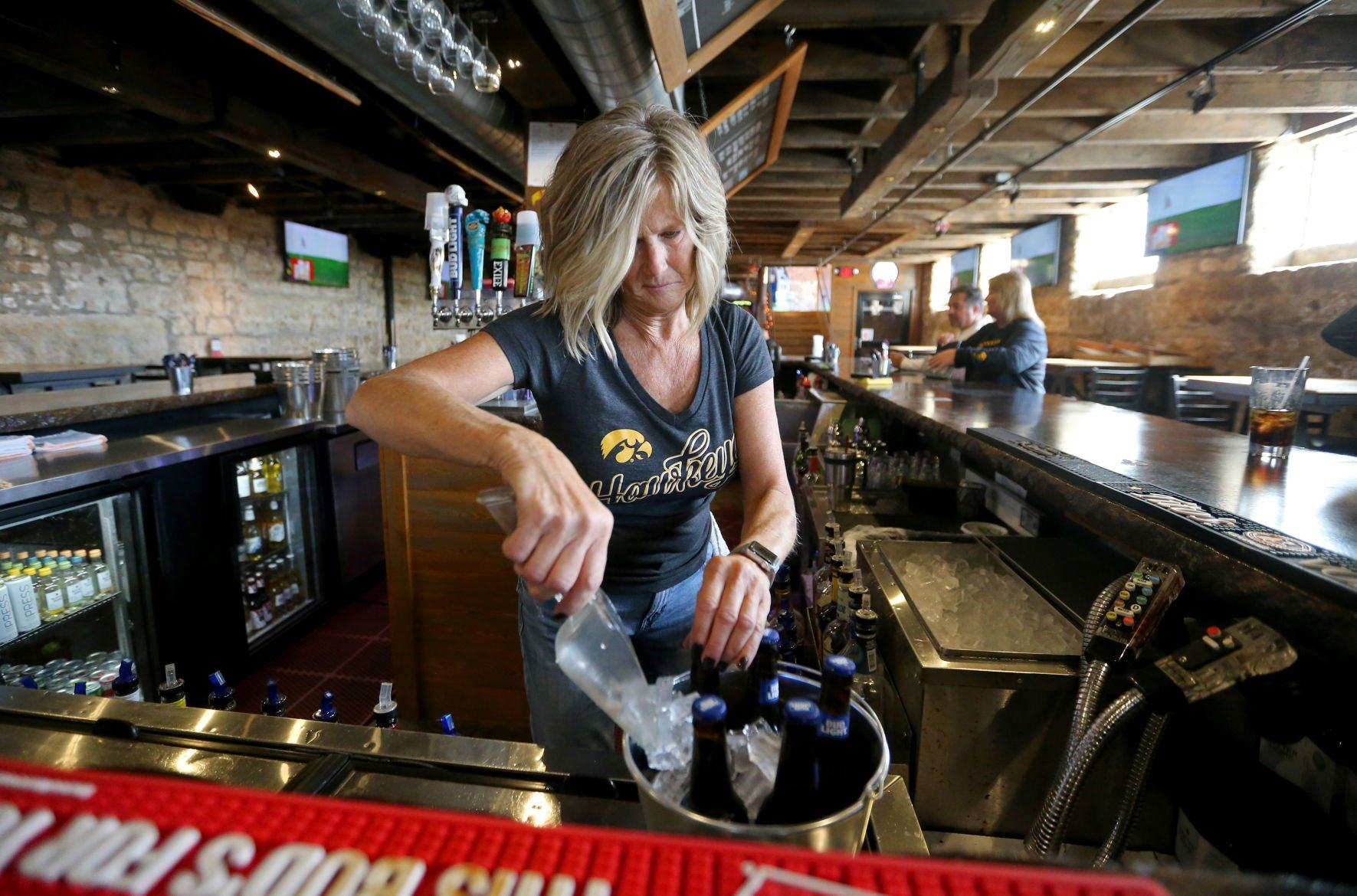 Co-owner Laurie Paulsen fills a bucket with beer at The Dungeon in Dubuque on Saturday, Oct. 1, 2022.    PHOTO CREDIT: JESSICA REILLY