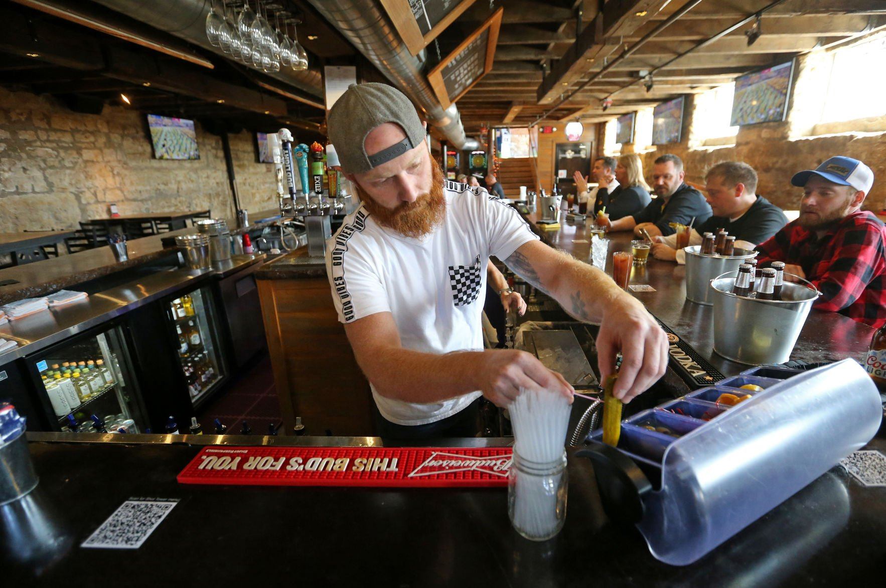 Co-owner Jake Roth makes a drink at The Dungeon in Dubuque on Saturday.    PHOTO CREDIT: JESSICA REILLY