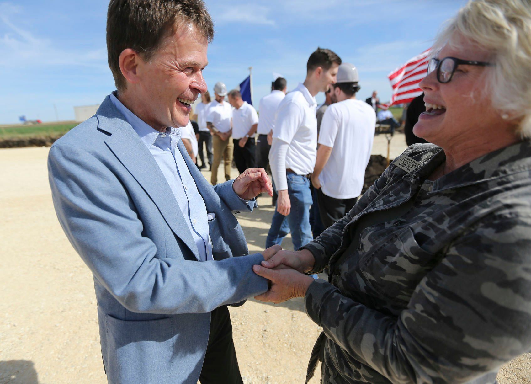 Wolfgang Buehler, co-owner of Ancient Brands Milling, chats with Delaware County Economic Development Executive Director Donna Boss after a groundbreaking event on Tuesday, Oct. 4, 2022. The manufacturer, which makes organic and non-GMO puffed grains, has planned a $26.5 million, 92,000-square-foot project in Dyersville’s 20 West Industrial Park.    PHOTO CREDIT: Dave Kettering