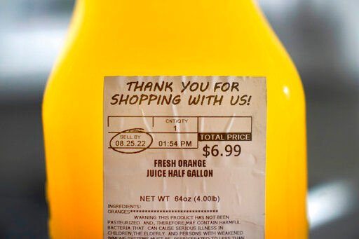 A "SELL BY" date is circled on a half gallon of fresh squeezed orange juice, Sunday, Aug. 21, 2022, in Chicago. As awareness grows around the world about the problem of food waste, one culprit in particular is drawing scrutiny: “best before” labels. Manufacturers have used the labels for decades to estimate peak freshness. Unlike “use by” labels, which are found on perishable foods like meat and dairy, “best before” labels have nothing to do with safety and may encourage consumers to throw away food that’s perfectly fine to eat. (AP Photo/Charles Rex Arbogast)    PHOTO CREDIT: Charles Rex Arbogast