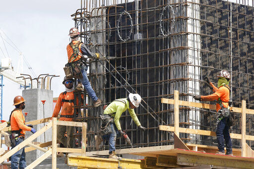 FILE - Construction workers fasten the frame of a new building, Monday, May 3, 2021, in Miami. The number of available jobs in the U.S. plummeted in August 2022 compared with July as businesses grow less desperate for workers, a trend that could cool chronically high inflation. (AP Photo/Marta Lavandier, File)    PHOTO CREDIT: Marta Lavandier