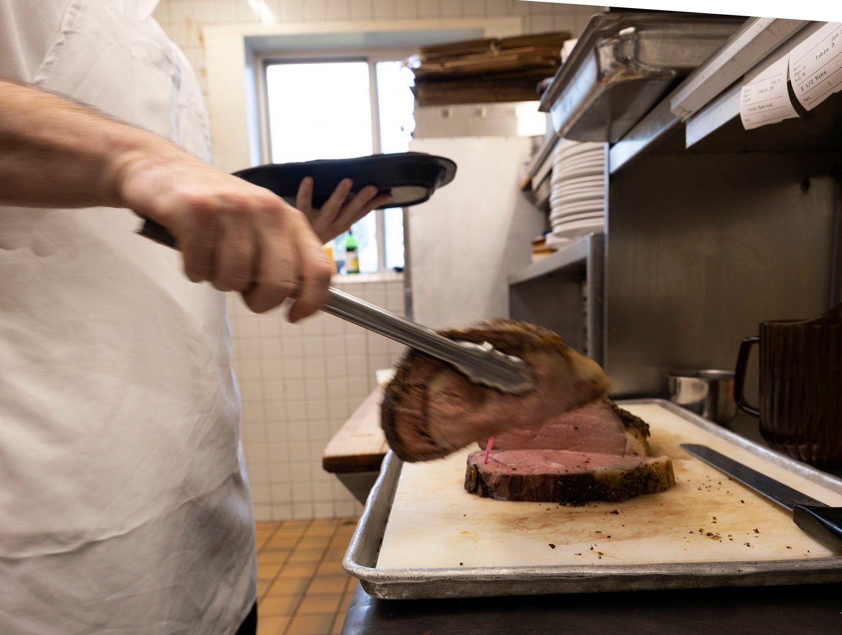 Prime rib being plated in the kitchen.    PHOTO CREDIT: Stephen Gassman