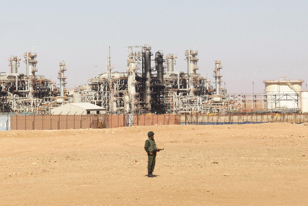 An Algerian soldier stands guard at the gas plant in Ain Amenas, seen in background. While Africa