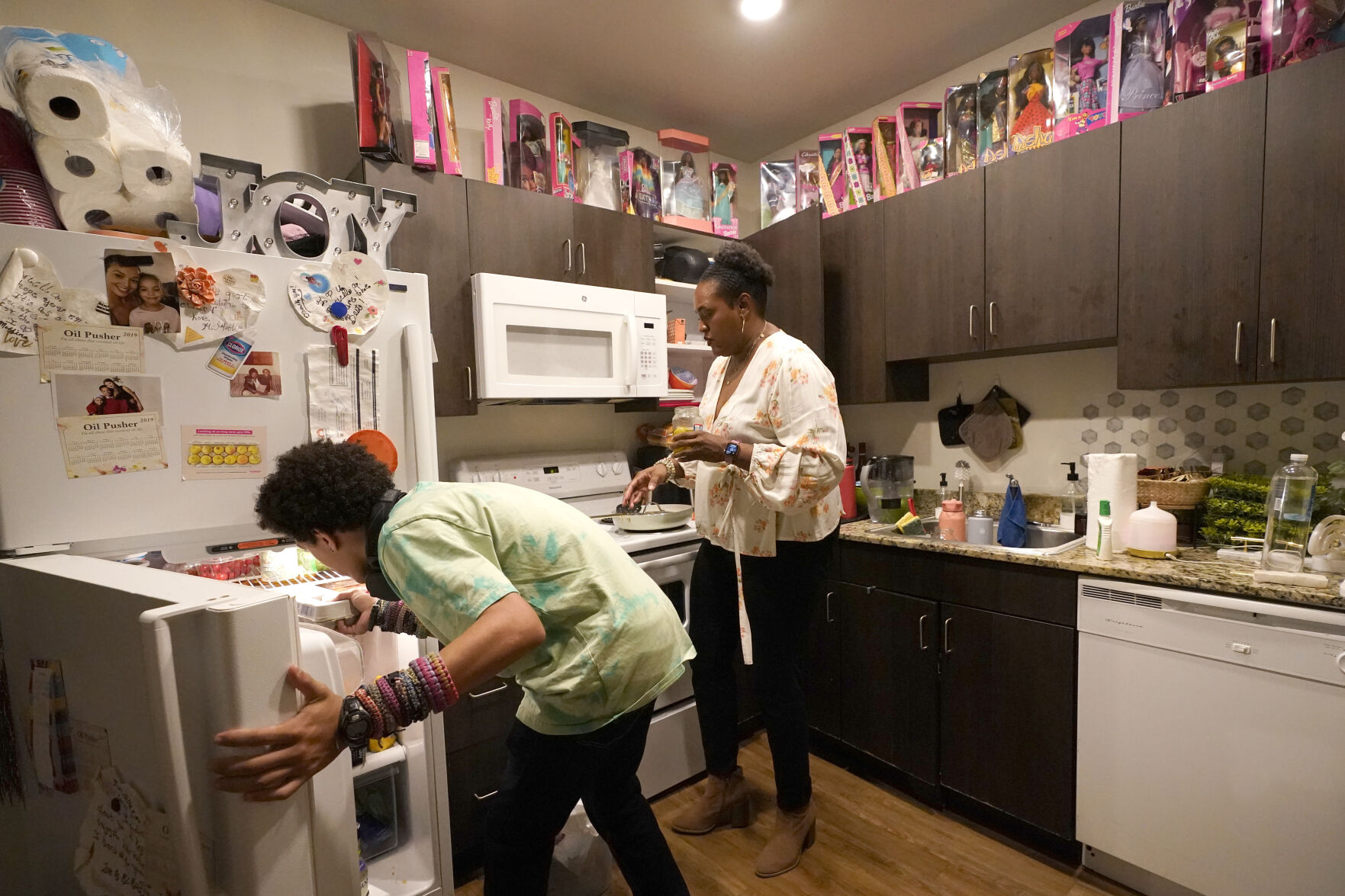 <p>Miles Fallon, left, and his mother, Marla Williams, work in the kitchen as she prepares dinner at their home in Chicago, Wednesday, Oct. 12, 2022. During remote learning, Williams says Miles lost motivation and wouldn’t do his assignments. Once he went back on a hybrid schedule in spring 2021, he started doing well again, she says. (AP Photo/Charles Rex Arbogast)</p>   PHOTO CREDIT: Charles Rex Arbogast - staff, AP