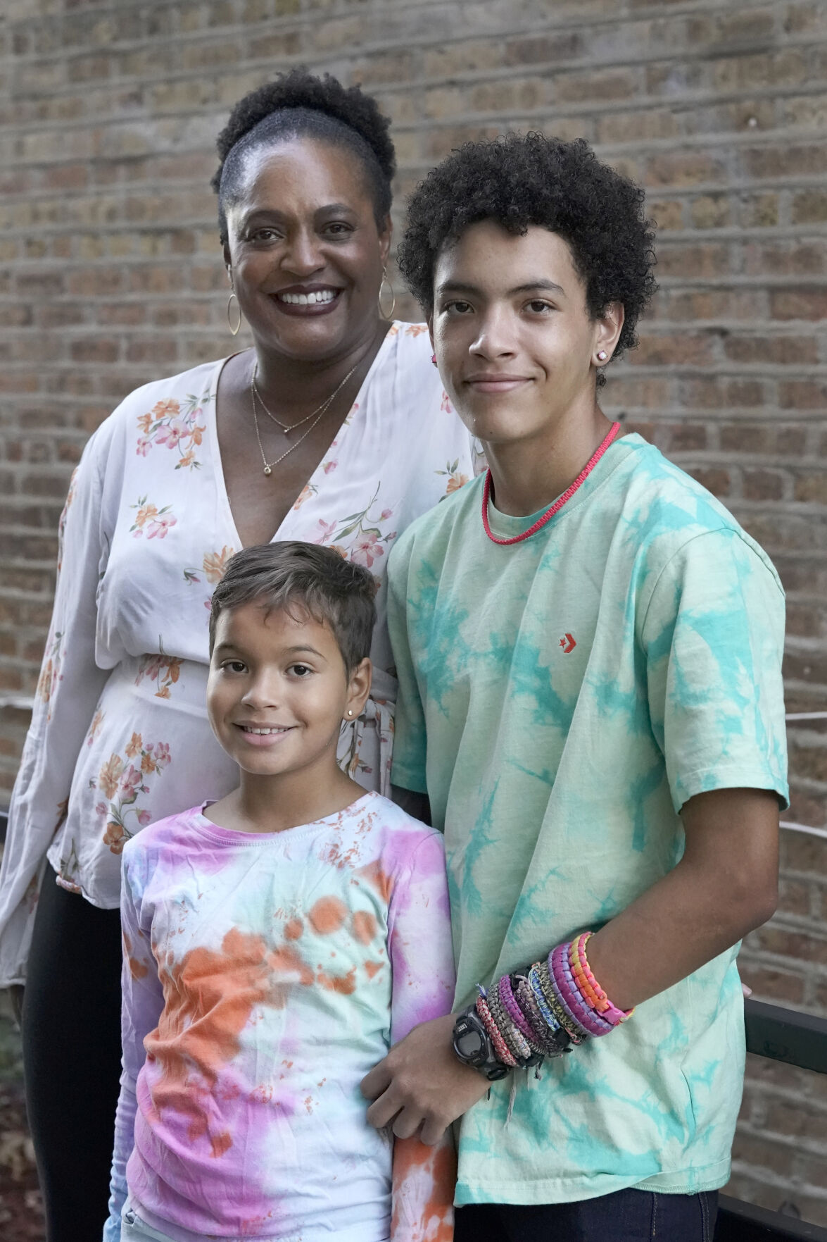 <p>Marla Williams, left, her daughter Mariella Fallon, center, and son Miles Fallon, stand for portrait outside their Chicago home Wednesday, Oct. 12, 2022. Williams initially supported the Chicago Public Schools decision to instruct students online during the fall of 2020. Williams, a single mother, has asthma, as do her two children. While she was working, she enlisted her father, a retired teacher, to supervise her children’s studies. (AP Photo/Charles Rex Arbogast)</p>   PHOTO CREDIT: Charles Rex Arbogast - staff, AP