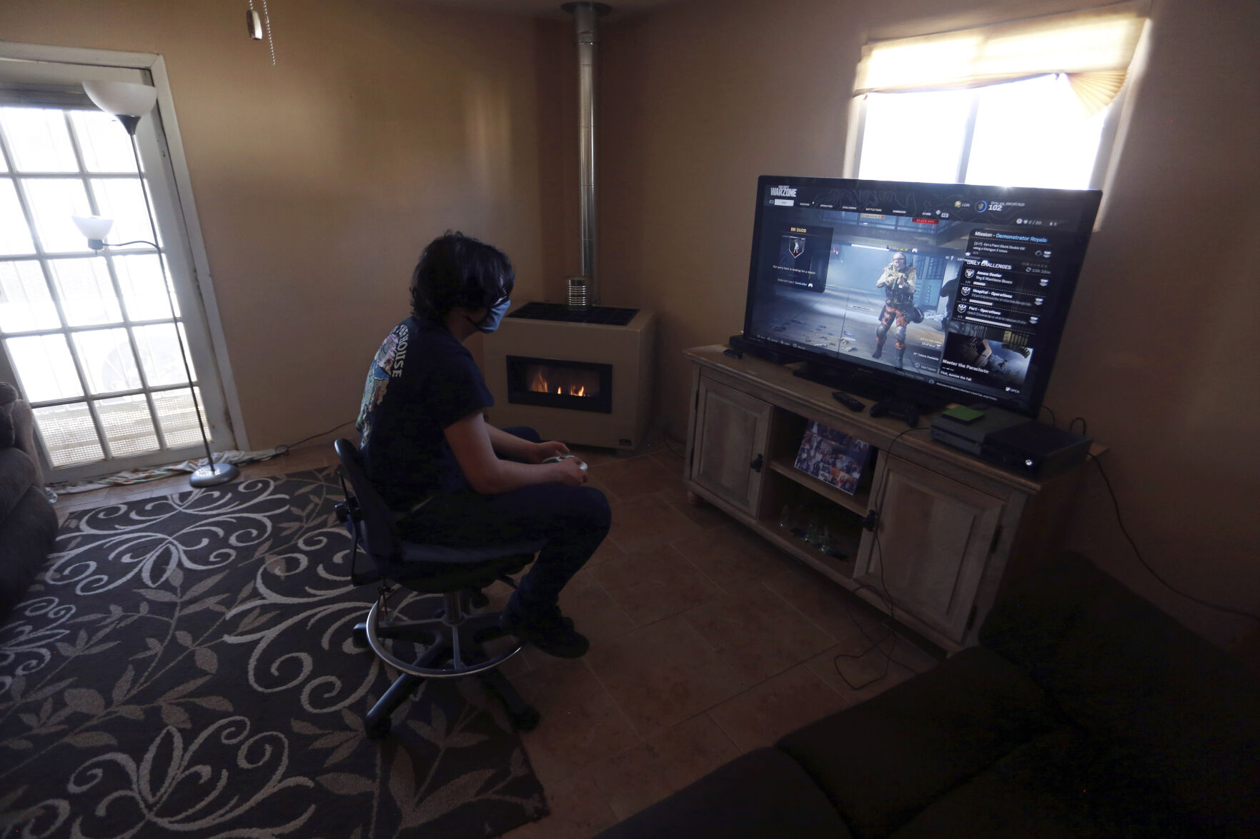 <p>FILE - Javin Lujan Lopez, 17, a senior at Pojoaque High School, plays video games at his house, Feb. 22, 2021, in Española, N.M. In interviews with The Associated Press, close to 50 school leaders, teachers, parents and health officials reflected on decisions to keep students in extended online learning, especially during the spring semester of 2021. (AP Photo/Cedar Attanasio, File)</p>   PHOTO CREDIT: Cedar Attanasio - staff, AP