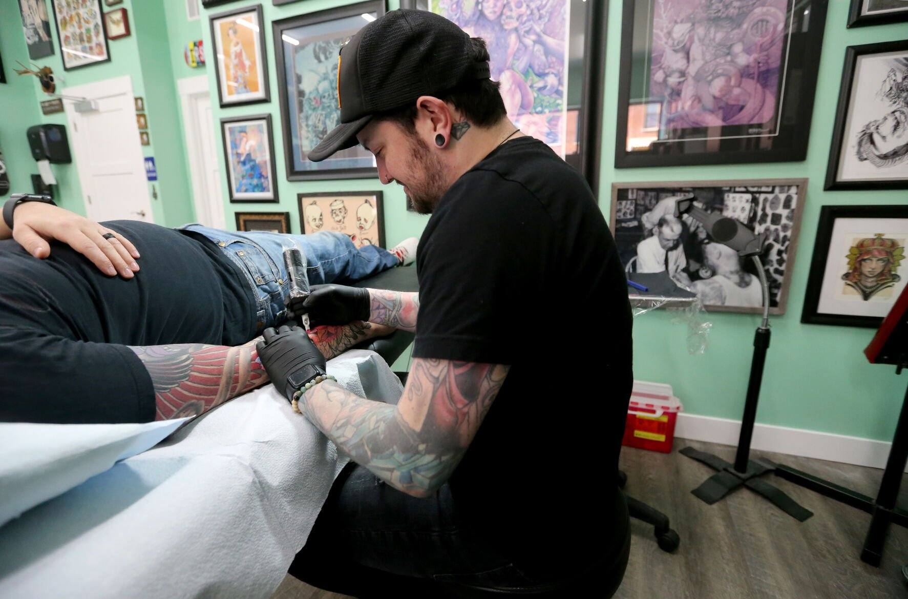 Alec Bauer tattoos Dan Gibson, of Dubuque, at First Light Tattoo & Gallery in Dubuque on Friday, Oct. 21, 2022.    PHOTO CREDIT: JESSICA REILLY