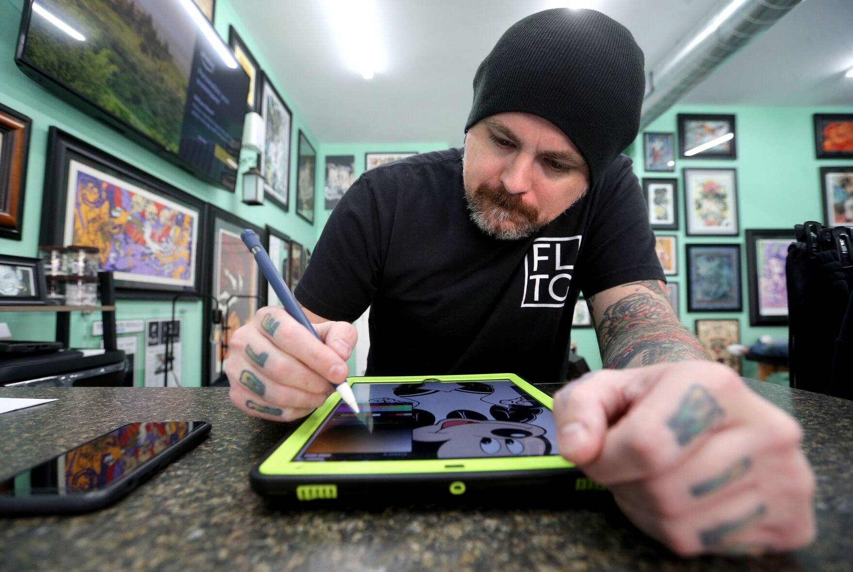Chris Hale works on a design for a customer at First Light Tattoo & Gallery in Dubuque on Friday, Oct. 21, 2022.    PHOTO CREDIT: JESSICA REILLY