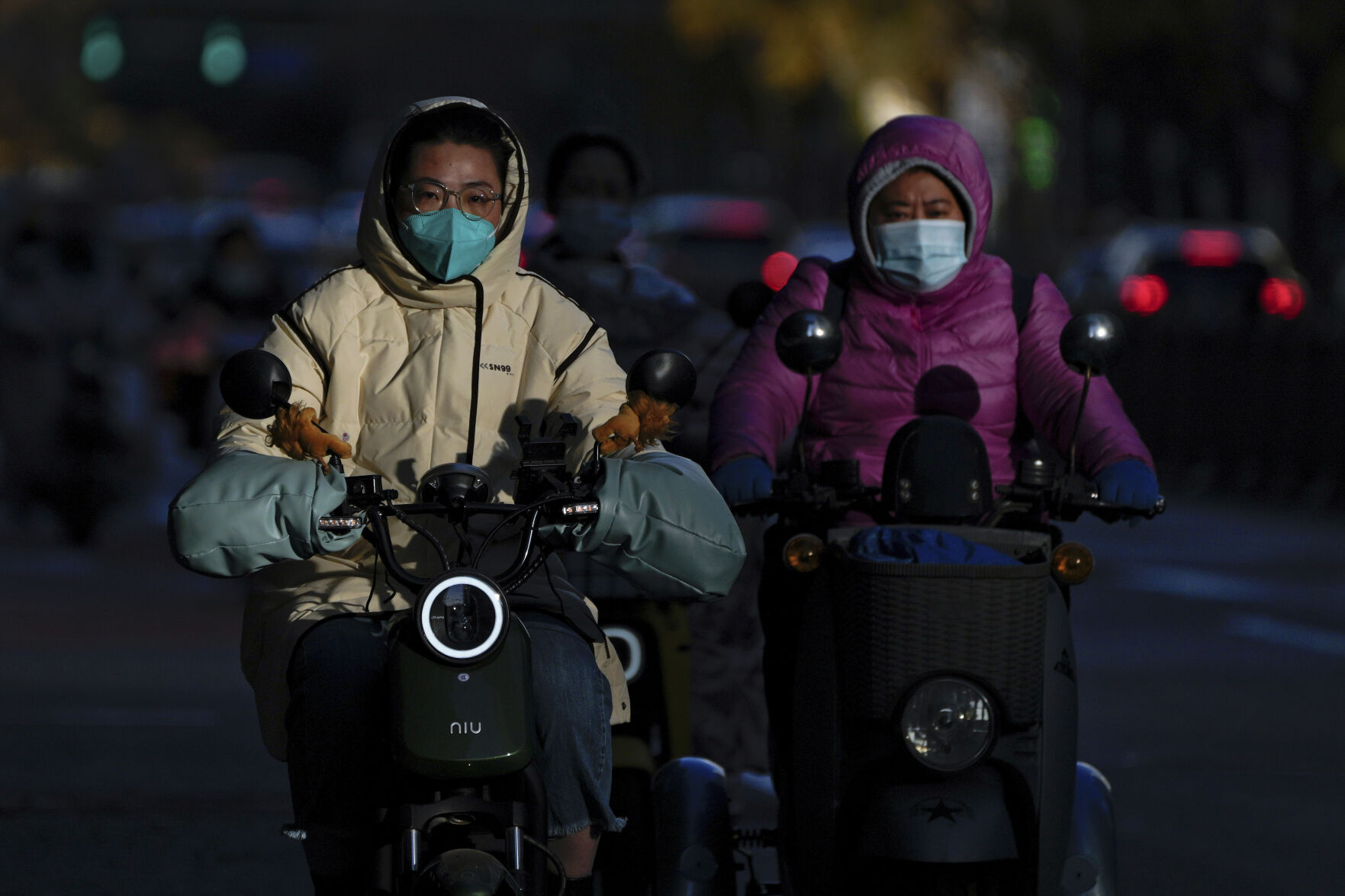 <p>Motorists wearing face masks ride their electric-powered scooters on a street during the morning rush hour in Beijing, Monday, Oct. 31, 2022. (AP Photo/Andy Wong)</p>   PHOTO CREDIT: Andy Wong - staff, AP