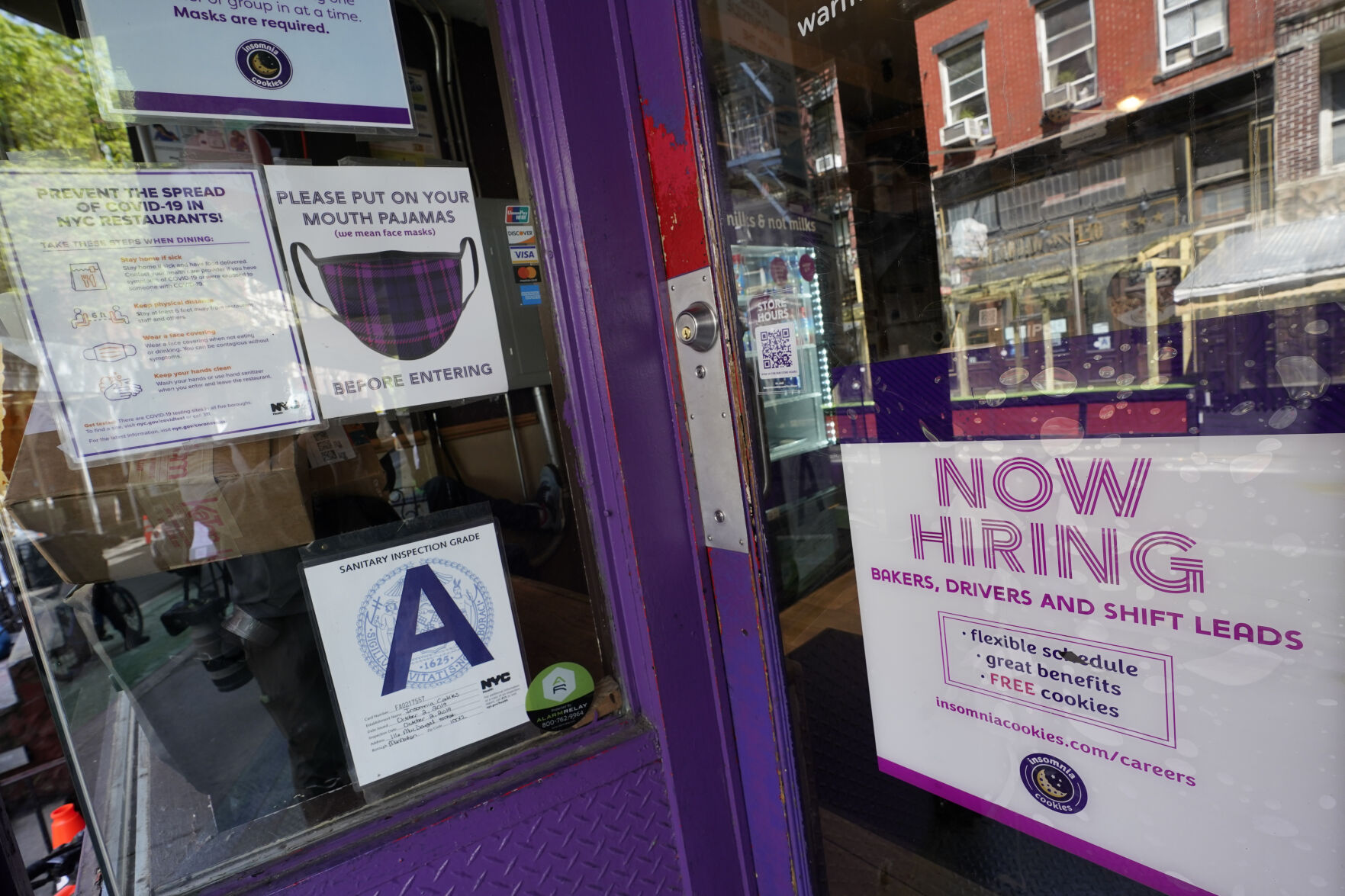 <p>FILE - In this May 4, 2021 file photo, a signs announcing they are hiring hangs in the window of a restaurant in the Greenwich Village neighborhood of Manhattan in New York. Starting this week, job-seekers in New York City will have access to a key piece of information: how much money they can expect to earn for an advertised opening. (AP Photo/Mary Altaffer, File)</p>   PHOTO CREDIT: Mary Altaffer