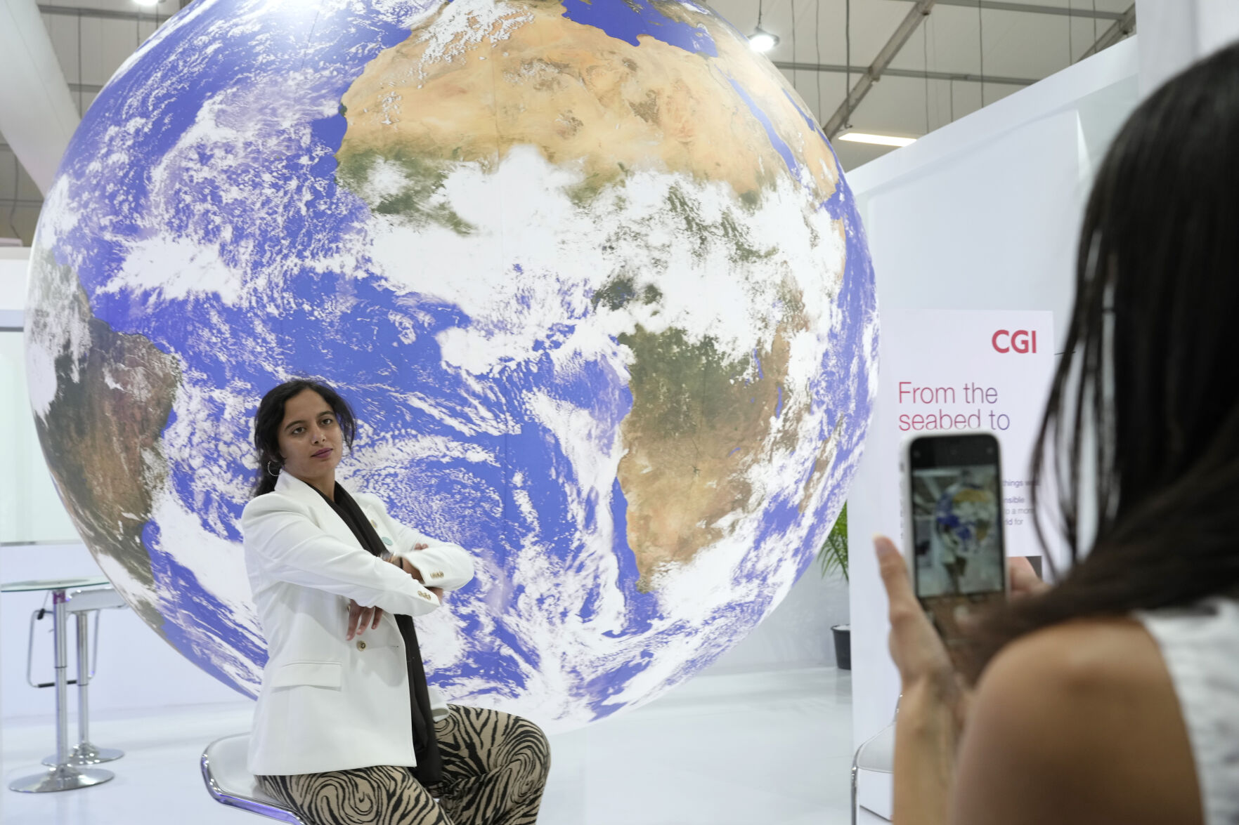 <p>A woman poses for photos at the COP27 U.N. Climate Summit, Monday, Nov. 7, 2022, in Sharm el-Sheikh, Egypt. (AP Photo/Peter Dejong)</p>   PHOTO CREDIT: Peter Dejong - staff, AP