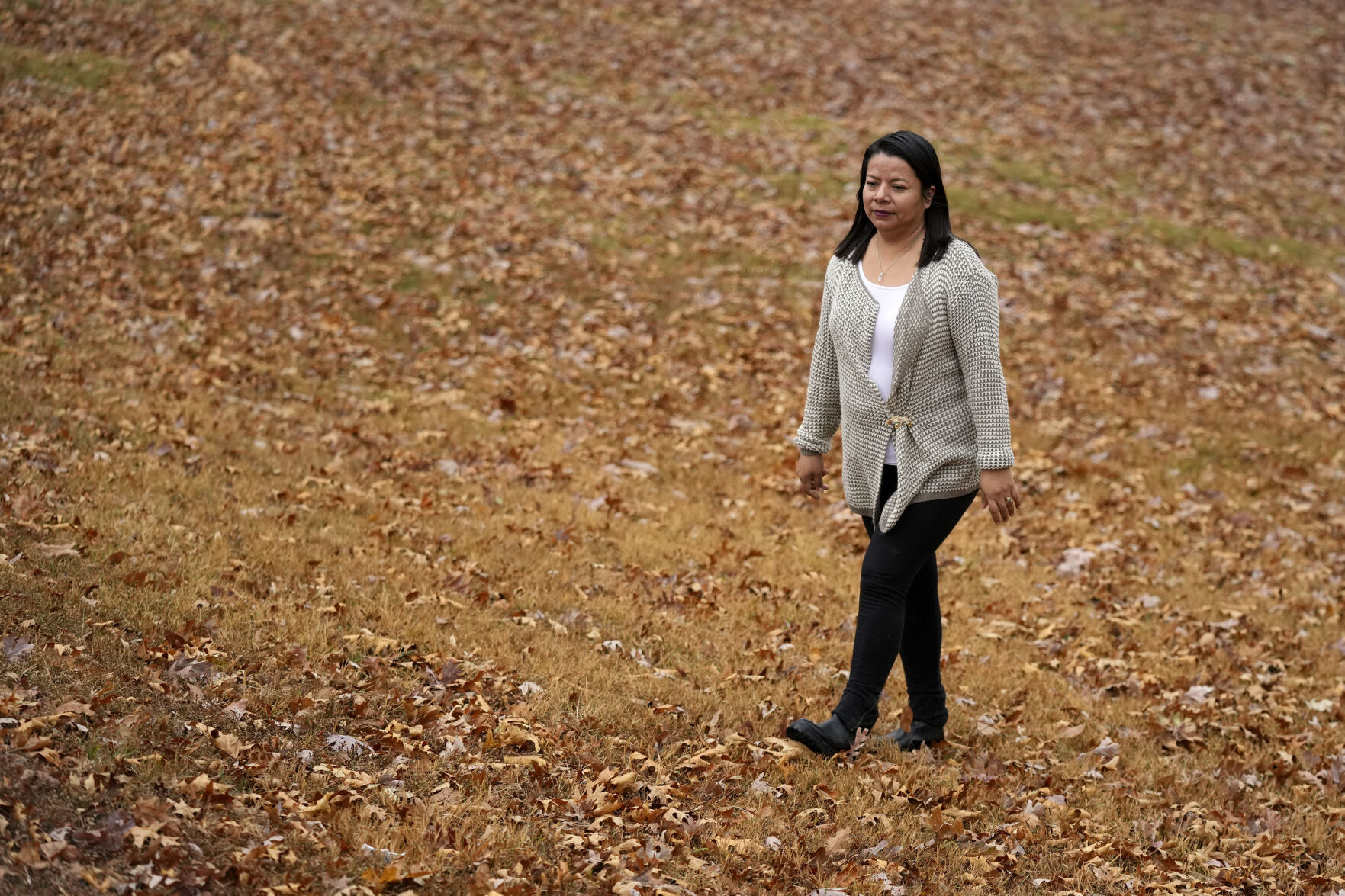 <p>Abi Suddarth walks through the leaves at Wyandotte County Lake, Friday, Nov. 4, 2022, in Kansas City, Kan. Suddarth is still undecided how she will vote in the upcoming election, citing divisiveness among political parties and a need for the country to find common ground. (AP Photo/Charlie Riedel)</p>   PHOTO CREDIT: Charlie Riedel - staff, AP