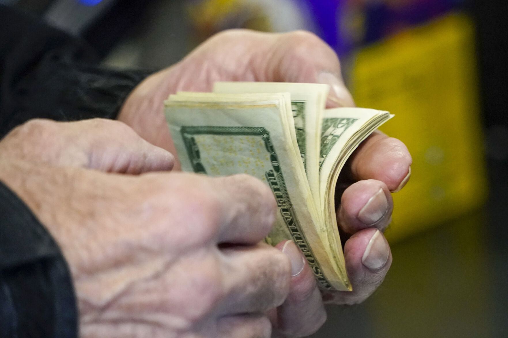 <p>A customer thumbs through his money as he buys tickets for the Monday Powerball drawing with an annuity value of at least $1.9 billion, Monday, Nov. 7, 2022, at a convenience store in Renfrew, Pa. (AP Photo/Keith Srakocic)</p>   PHOTO CREDIT: Keith Srakocic - staff, AP