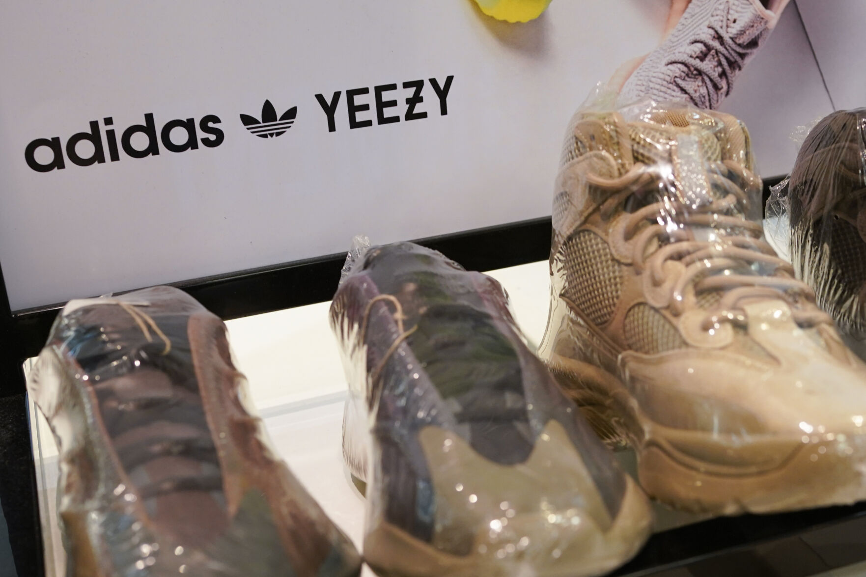 <p>A sign advertises Yeezy shoes made by Adidas at Kickclusive, a sneaker resale store, in Paramus, N.J., Tuesday, Oct. 25, 2022. Adidas has ended its partnership with the rapper formerly known as Kanye West over his offensive and antisemitic remarks, the latest company to cut ties with Ye and a decision that the German sportswear company said would hit its bottom line. (AP Photo/Seth Wenig)</p>   PHOTO CREDIT: Seth Wenig - staff, AP
