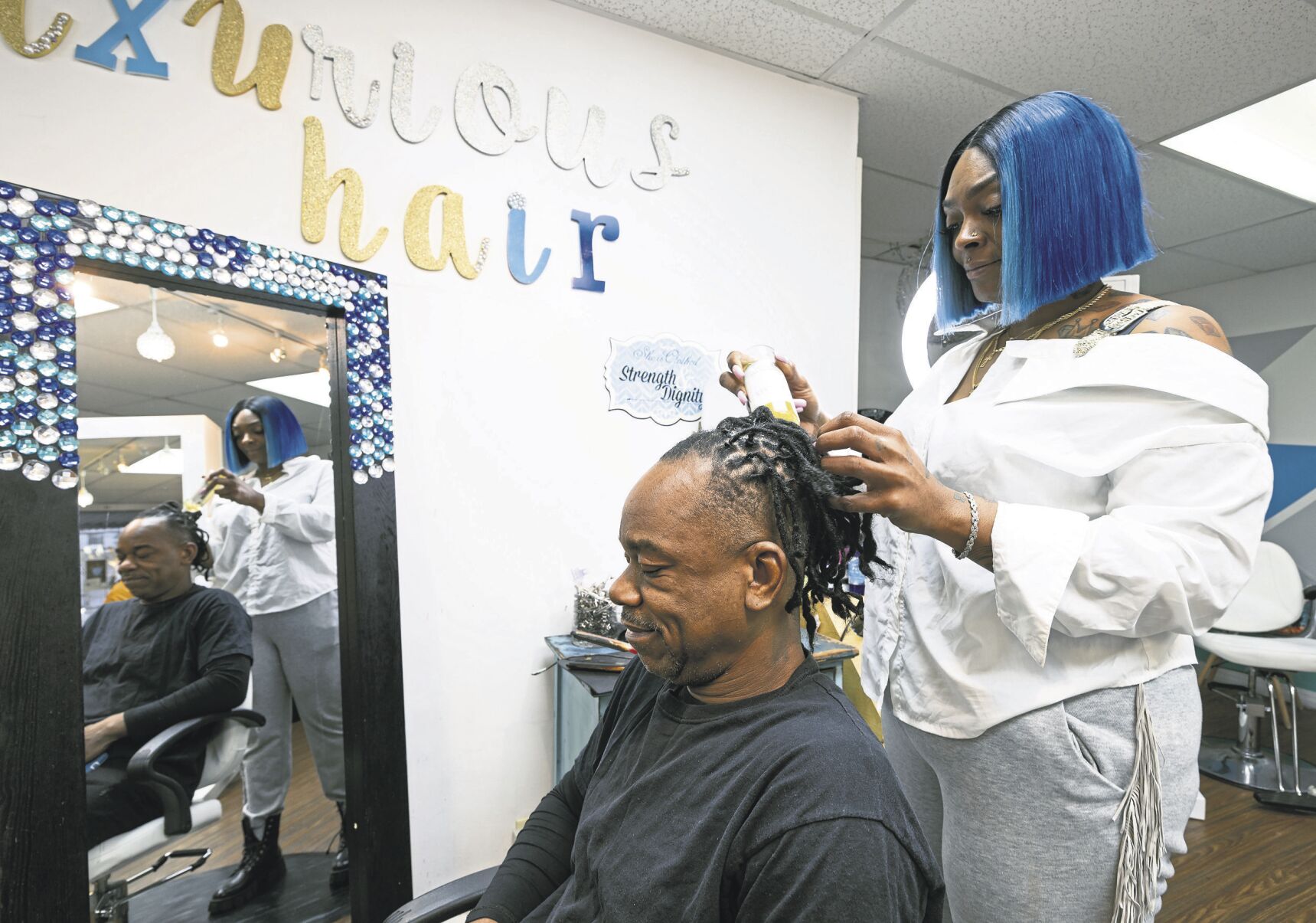 Luxurious Hair Spa owner Shamika Rainer styles the hair of Willie Dunbar. Rainer opened the Central Avenue shop because when she moved to Dubuque, there was no one to do her hair.    PHOTO CREDIT: Stephen Gassman