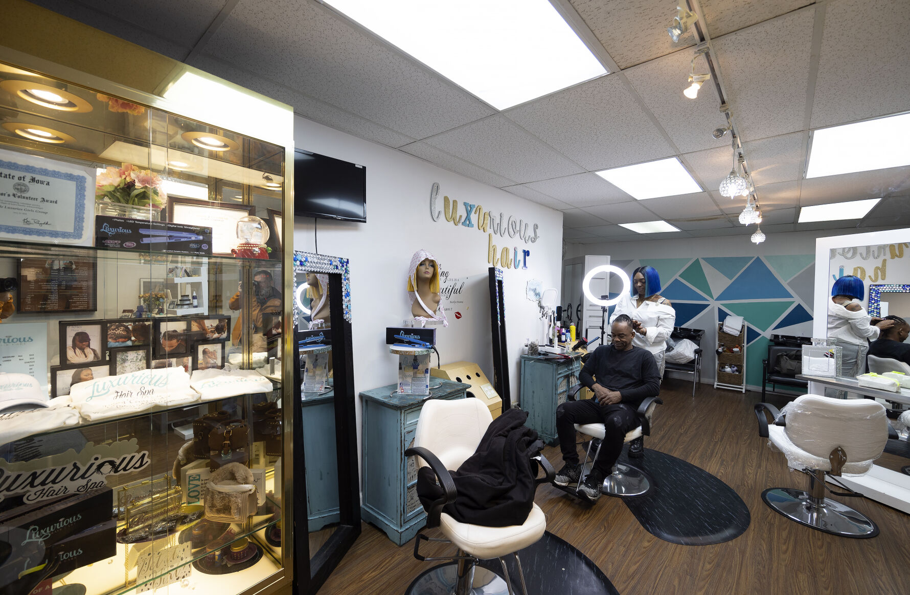 Salon owner Shamika Rainer works on the hair of Willie Dunbar at Luxurious Hair Spa on Central Avenue in Dubuque.    PHOTO CREDIT: Stephen Gassman