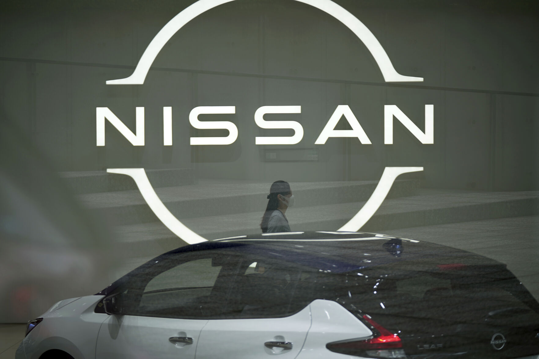 <p>FILE - A staff walking near a Nissan logo at Nissan headquarters is seen though a window on May 12, 2022, in Yokohama near Tokyo. Nissan’s profit fell 68% in the last quarter as a shortage of computer chips hindered the Japanese automaker’s ability to deliver vehicles to its customers.(AP Photo/Eugene Hoshiko, File)</p>   PHOTO CREDIT: Eugene Hoshiko - staff, AP