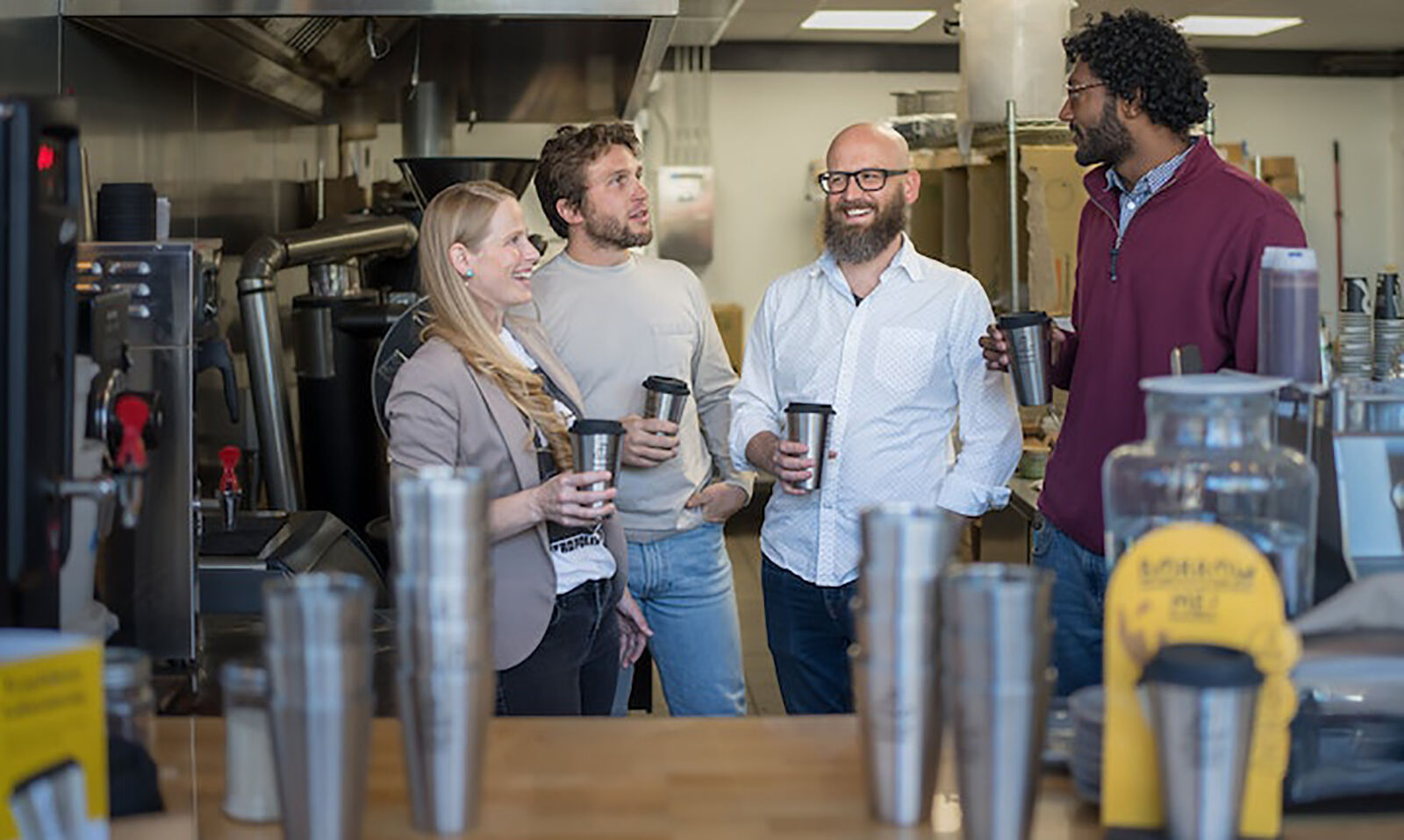 Forever Ware co-founder Natasha Gaffer (from left), Chief Financial Officer Lee Sweatt and co-founders Nick Krumholz and Nolan Singroy gather at Roots Coffee where Singroy is a regular customer and the shop uses their mugs.     PHOTO CREDIT: Tribune News Service