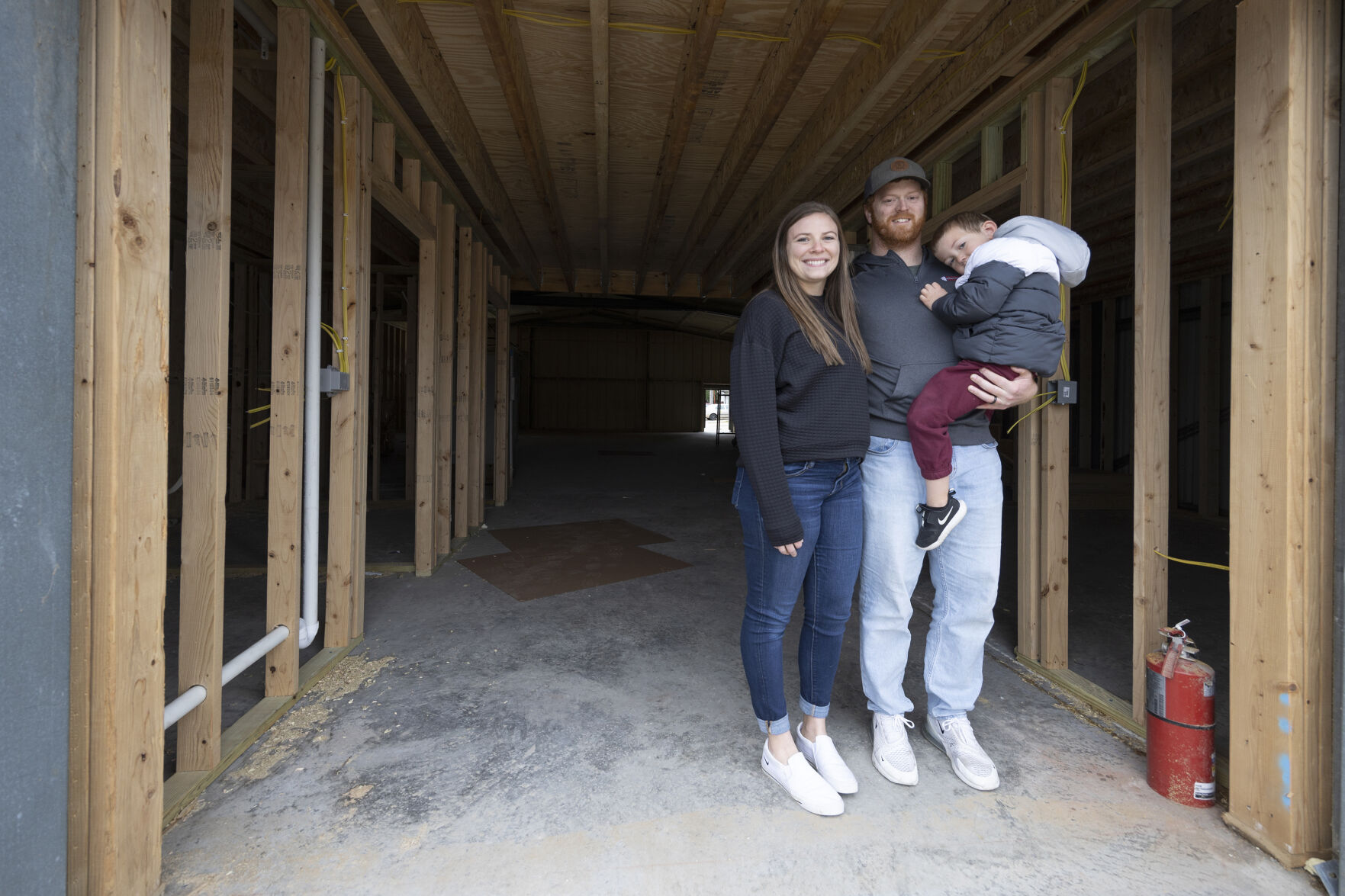 Owners Sammy, (left) Spencer and son Jaxon Scar inside what will become Timber City Fitness in Maquoketa, Iowa. Photo taken Friday, Nov. 12, 2022.    PHOTO CREDIT: Stephen Gassman
