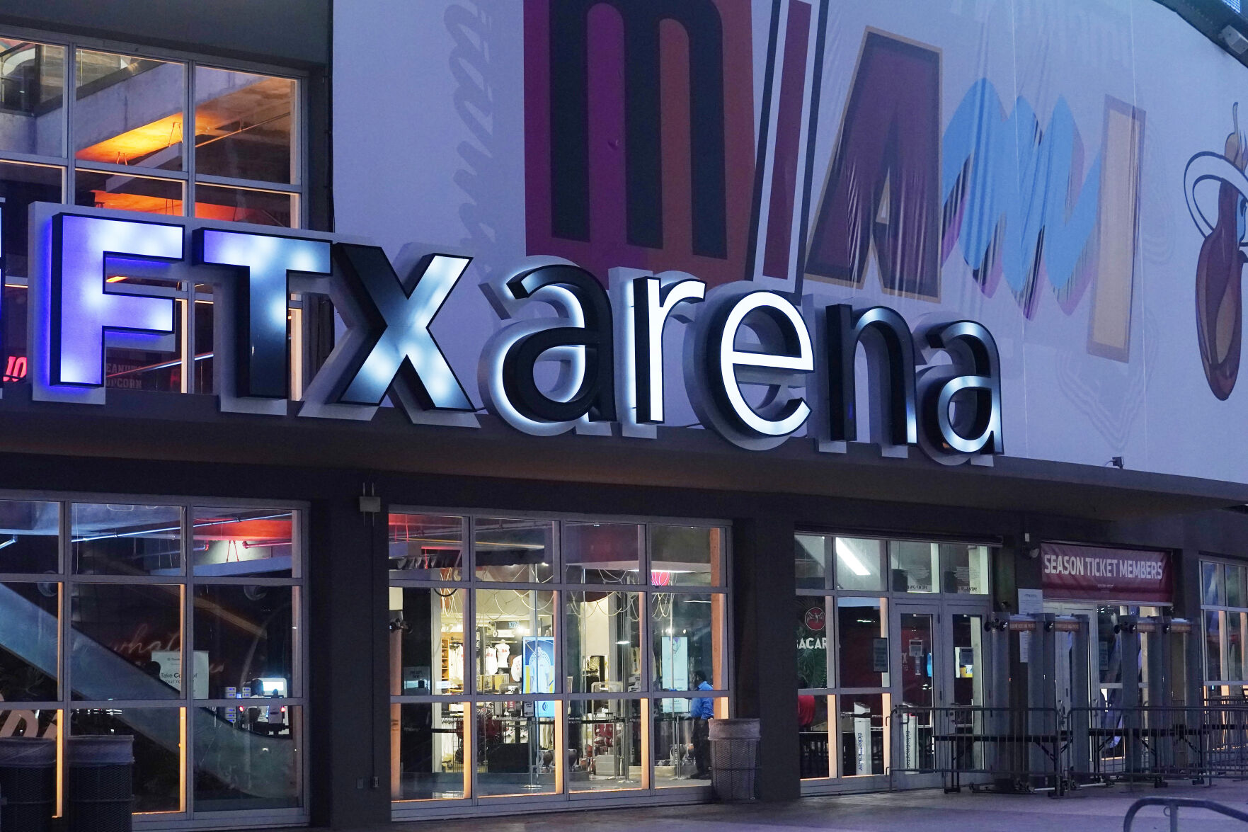 <p>FILE - A sign for the FTX Arena, where the Miami Heat basketball team plays, is illuminated on Nov. 12, 2022, in Miami. FTX filed for bankruptcy protection Friday, Nov. 11. (AP Photo/Marta Lavandier, File)</p>   PHOTO CREDIT: The Associated Press