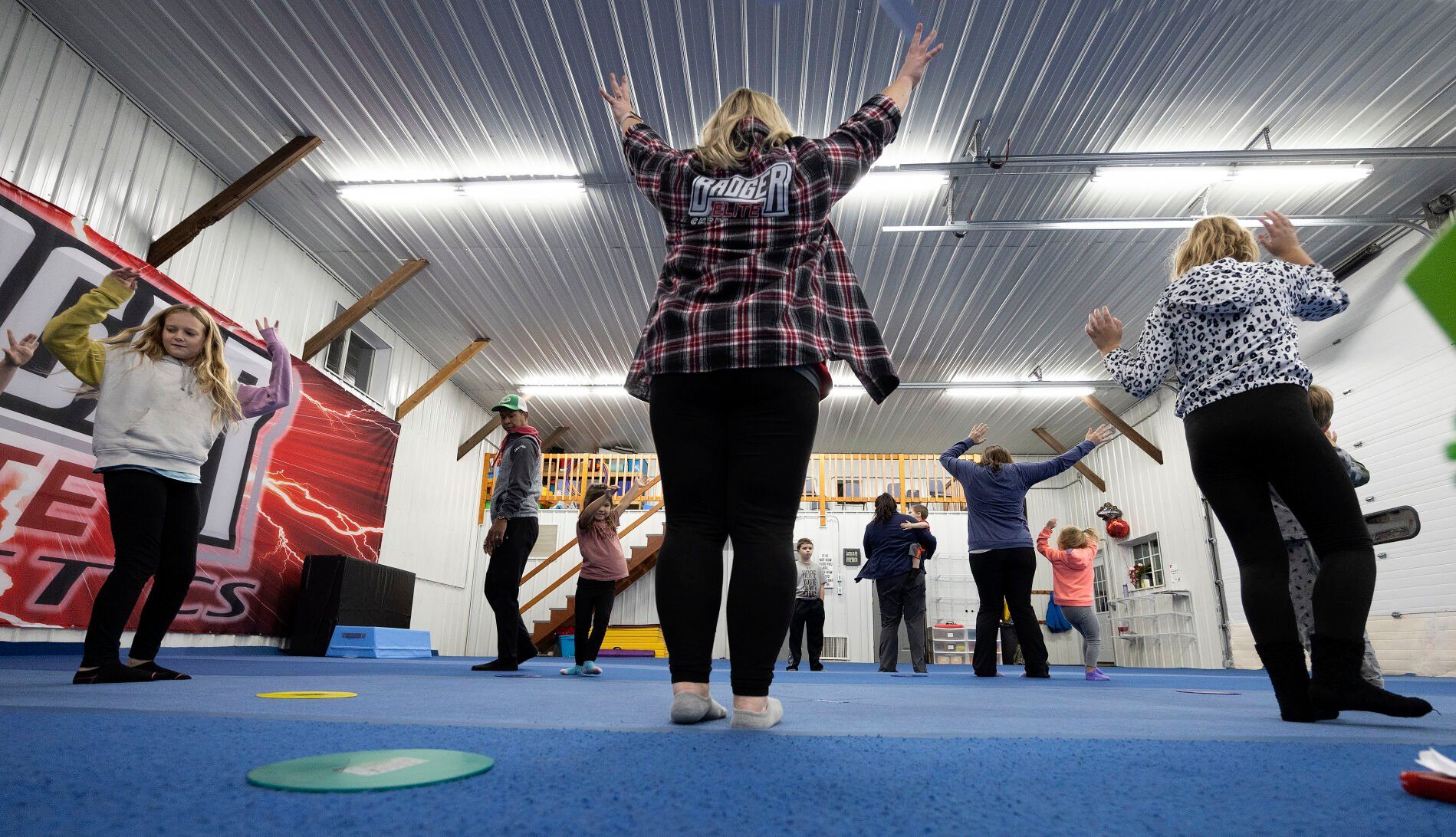 Co-owner Katie Daentl leads warm-up exercises during a "Mommy and Me Music Class" at Badger Elite Athletics in Shullsburg, Wis., on Wednesday, Nov. 16, 2022.    PHOTO CREDIT: Stephen Gassman