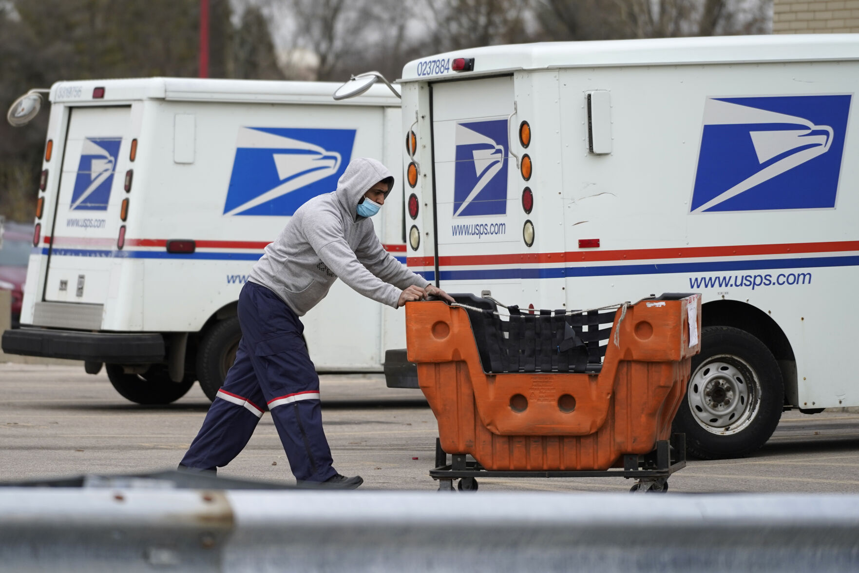 <p>FILE - A United States Postal Service employee works outside a post office in Wheeling, Ill., Dec. 3, 2021. The nation’s major shipping companies are in the best shape to get holiday shoppers’ packages delivered on time since the start of the pandemic, suggesting a return to normalcy. (AP Photo/Nam Y. Huh, File)</p>   PHOTO CREDIT: Nam Y. Huh - staff, AP
