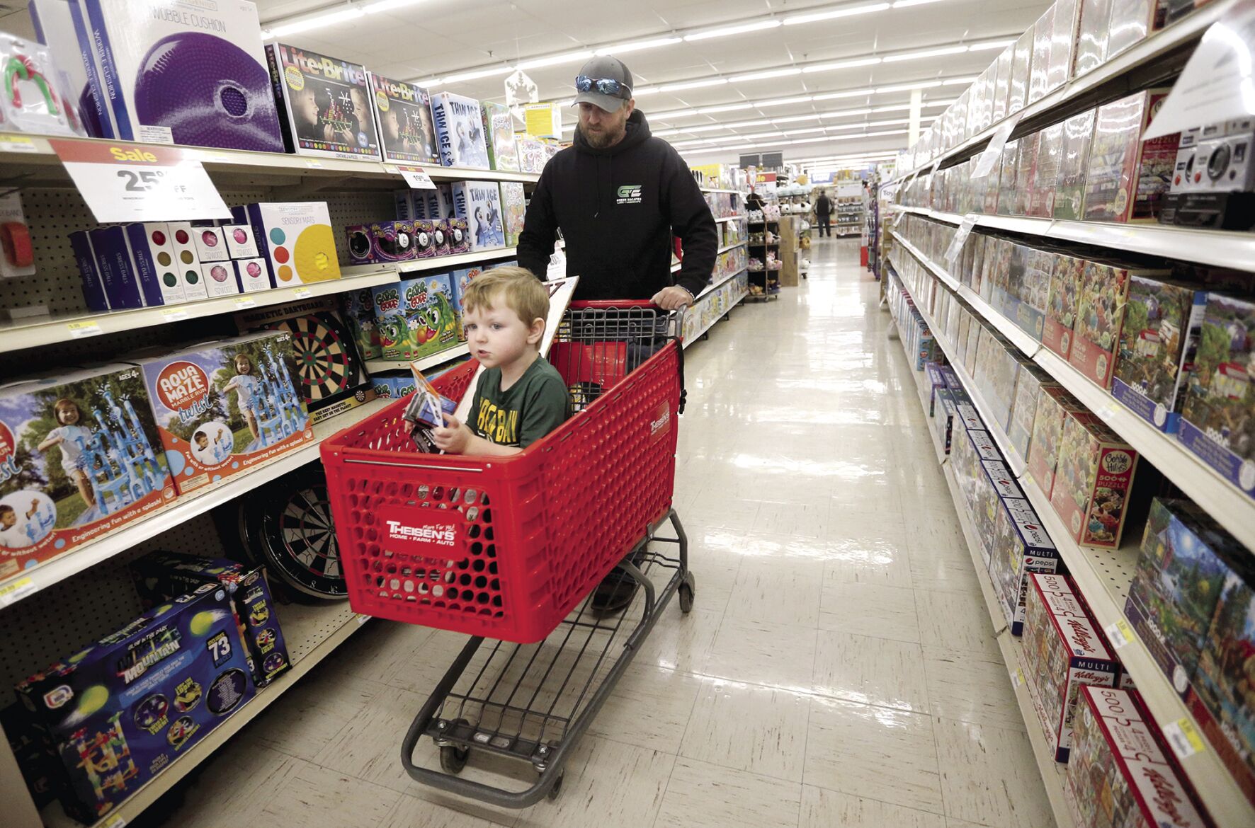 Joel Post and his son Kason, 5, both of Shullsburg, Wis., browse at Theisen’s Home-Farm-Auto in Dubuque on Monday.    PHOTO CREDIT: JESSICA REILLY