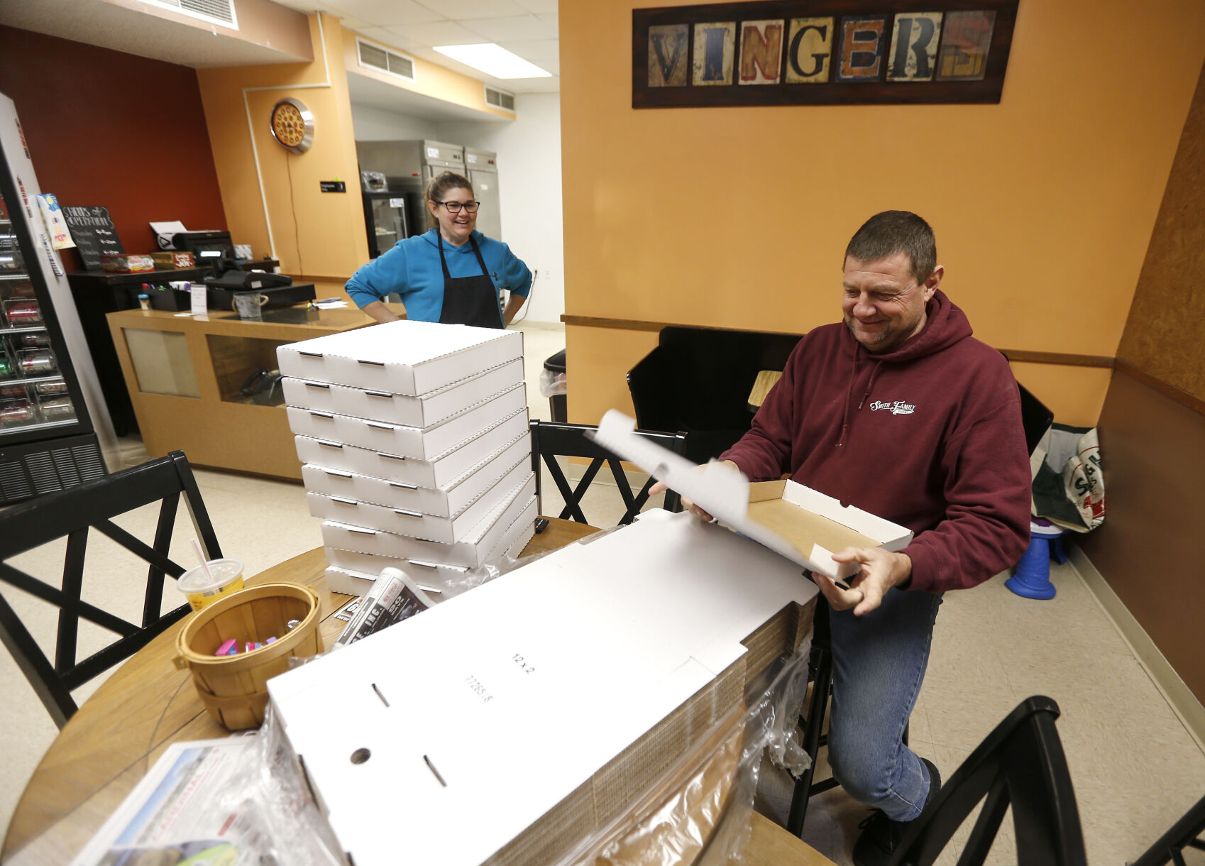 Owners of Vinger’s Pizza in Darlington, Wis., Val Smith and her husband Steve get boxes ready before opening Saturday, Nov. 26, 2022.    PHOTO CREDIT: Dave Kettering