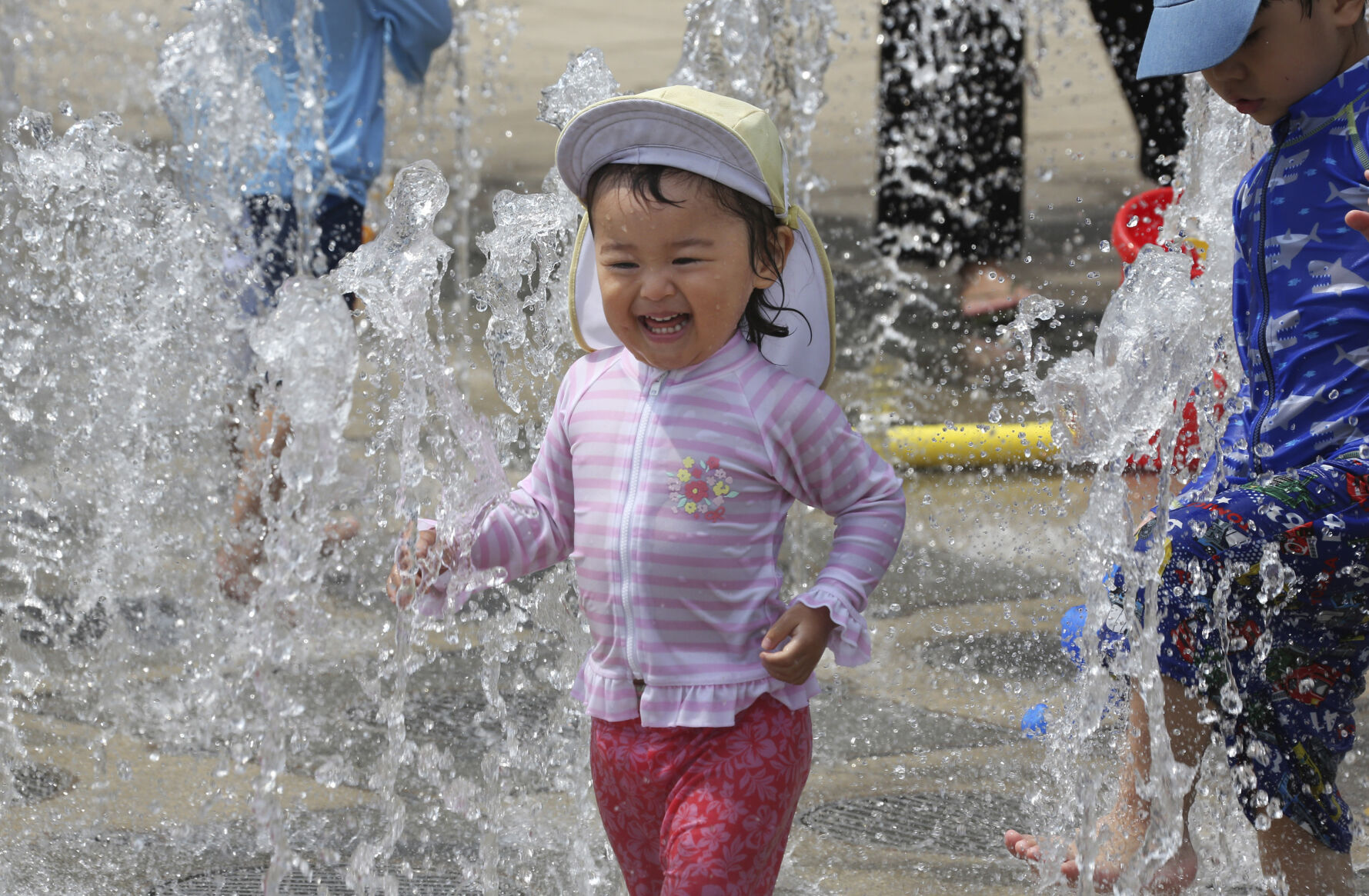 <p>Children play in the water to cool off at a park in Yokohama, near Tokyo, Tuesday, Aug. 18, 2020. The number of babies born in Japan in 2022 is below last year’s record low in what the the top government spokesman described as a “critical situation.” (AP Photo/Koji Sasahara)</p>   PHOTO CREDIT: Koji Sasahara 