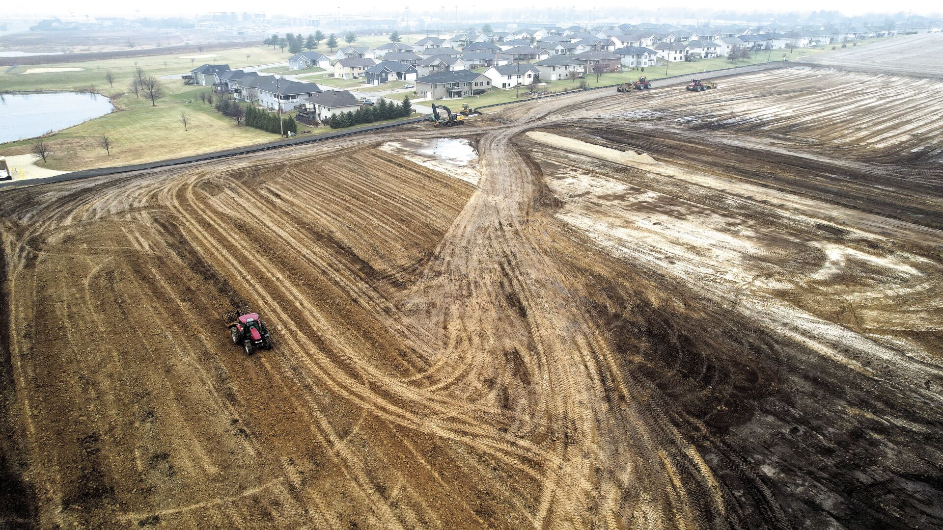 Machinery grooms a parcel of land that will be the site of a five-building apartment complex along Cox Springs Road in Peosta, Iowa.    PHOTO CREDIT: Dave Kettering